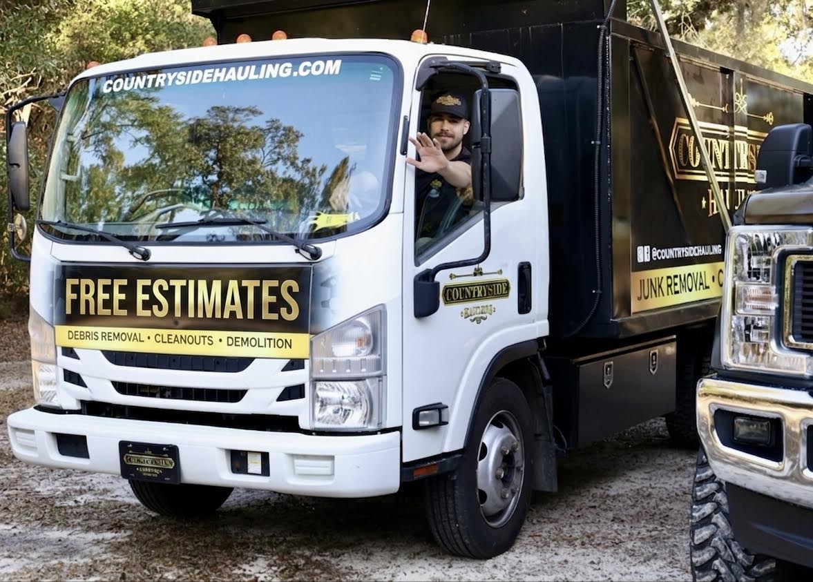 Countryside Hauling Isuzu NPR dump truck arriving in a Jacksonville driveway ready for junk removal